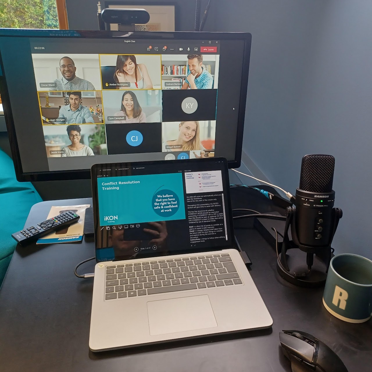 IKON Training professional online delivery setup - Microsoft Teams session on monitor with Conflict Resolution Training presentation on laptop and recording microphone