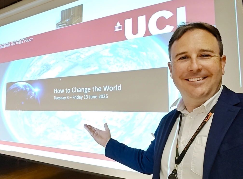Richard Williams presenting at UCL, pointing to the How to Change the World slide - the STEaPP Science Communication module context