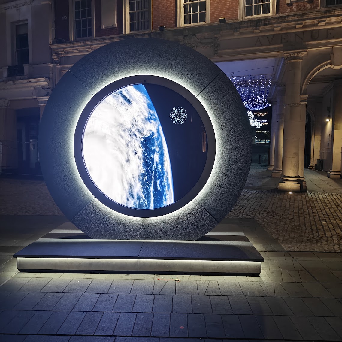 Large circular illuminated spherical display showing Earth from space - an example of immersive media installation technology considered for learning environments